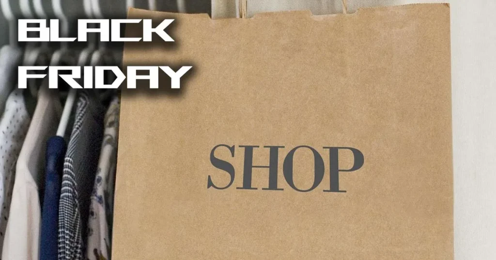 Black Friday shopping bag in front of a clothes rail